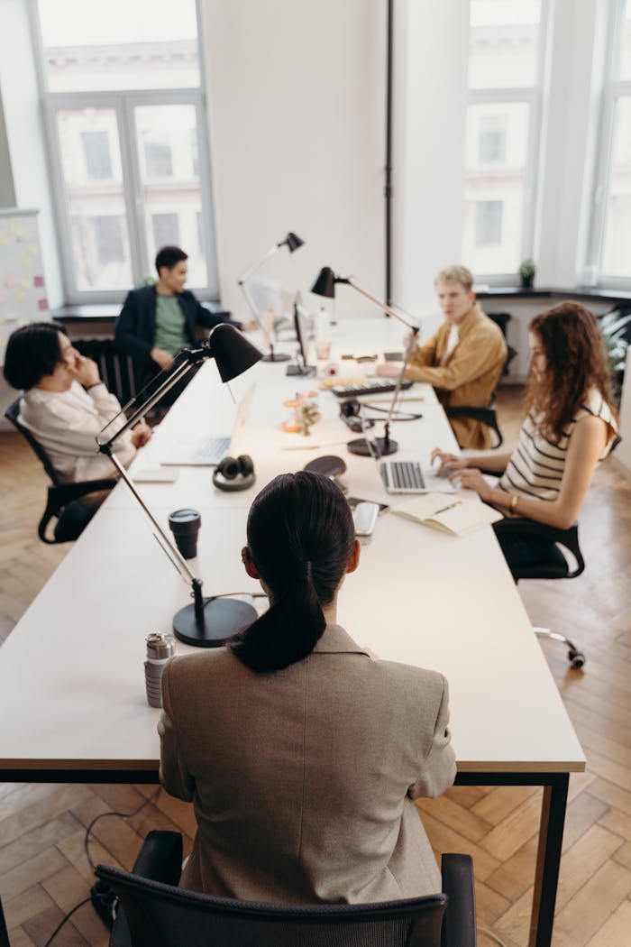 about-img Collaborative business meeting in a modern office with diverse colleagues.
